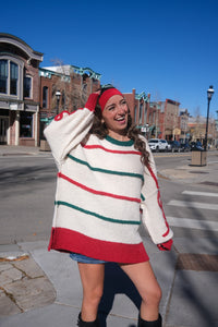 Woman wearing a colorful striped sweater 