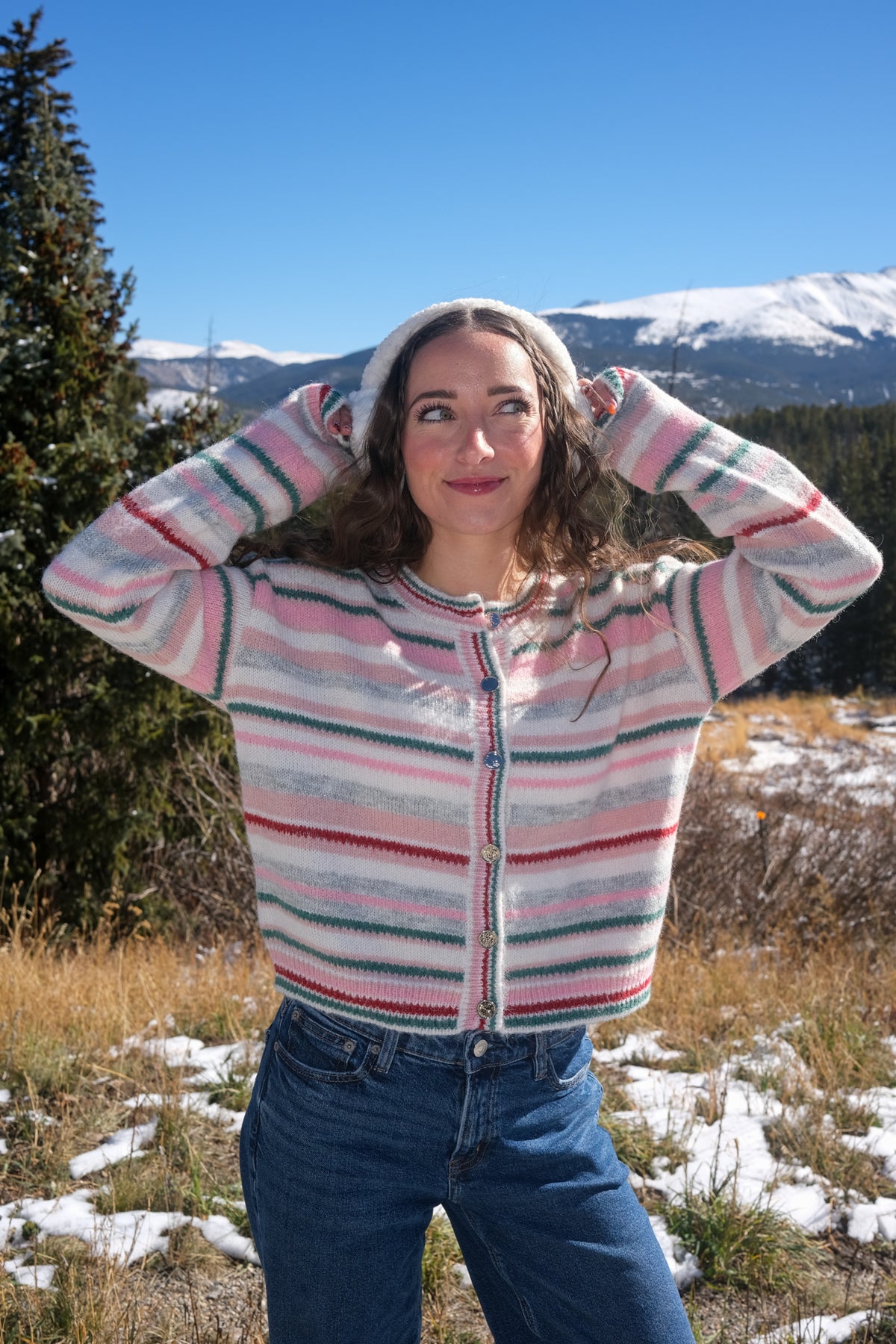 girl wearing pastel striped cardigan