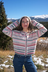 girl wearing pastel striped cardigan