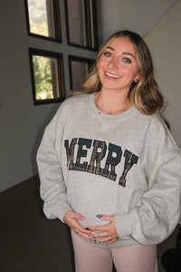 girl wearing light gray merry crewneck