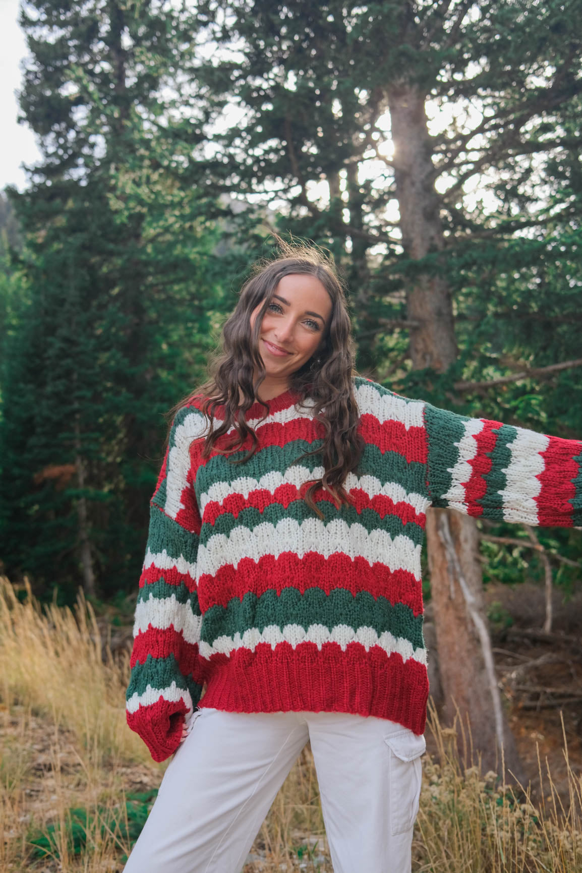 girl wearing red, green, and white knit sweater