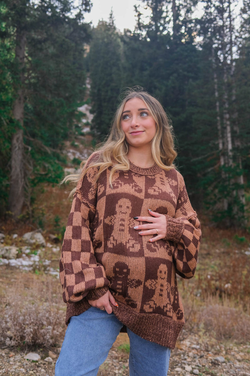 girl wearing brown gingerbread sweater