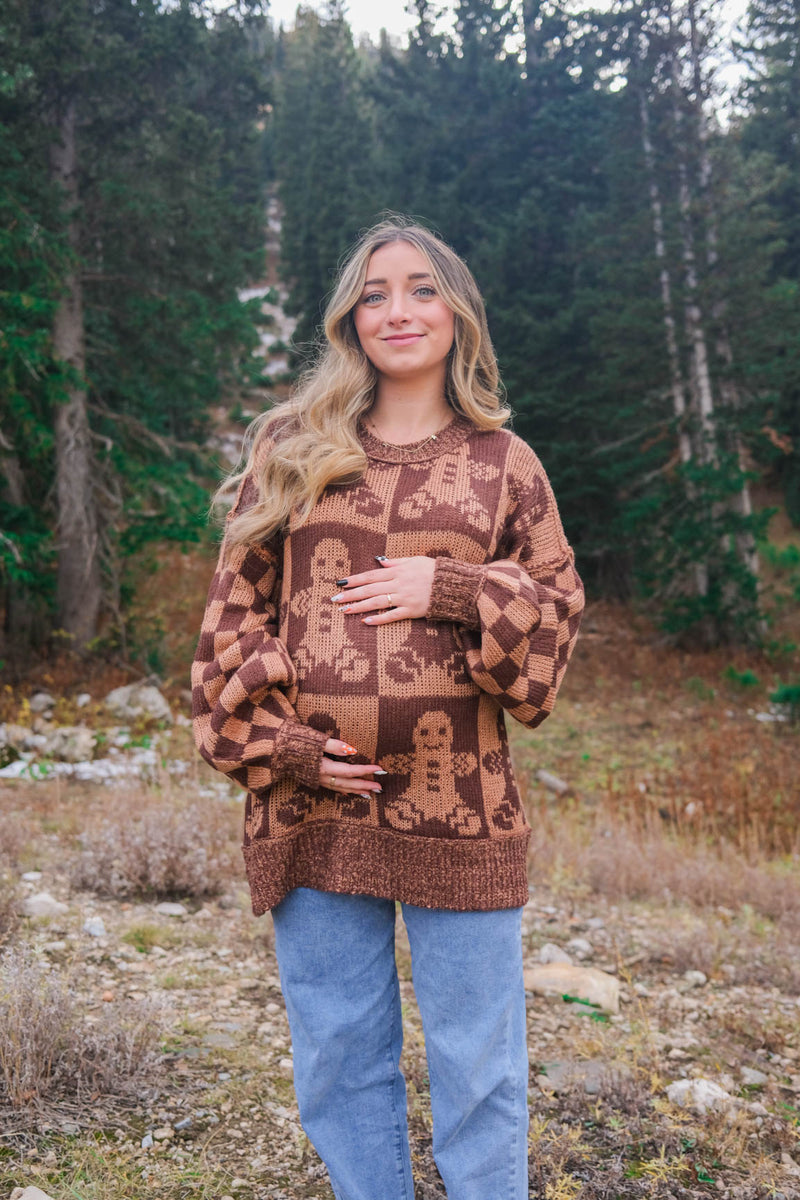 girl wearing brown gingerbread sweater