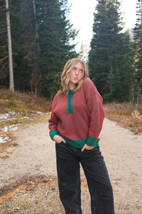 girl wearing red and green button down knit sweater