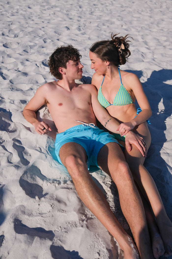 man wearing blue swim trunks