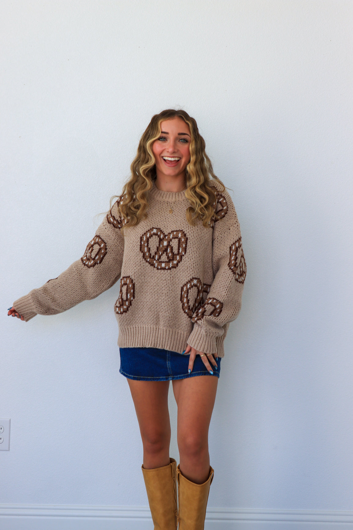 girl wearing tan and brown soft pretzel sweater