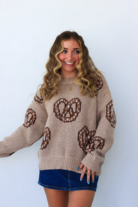 girl wearing tan and brown soft pretzel sweater