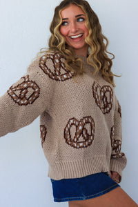 girl wearing tan and brown soft pretzel sweater