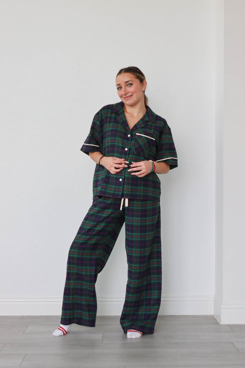 girl wearing dark green plaid pajamas