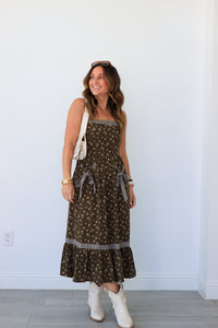 woman wearing brown floral maxi dress