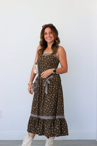 woman wearing brown floral maxi dress