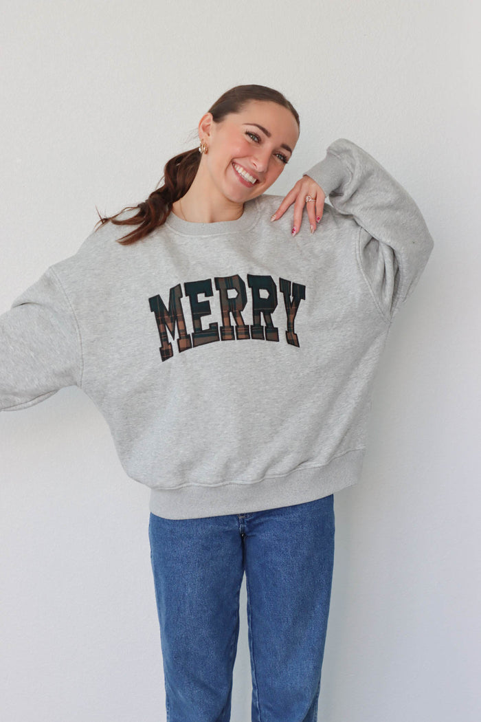 girl wearing light gray merry crewneck