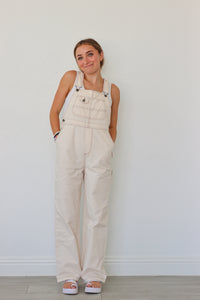 girl wearing cream overalls