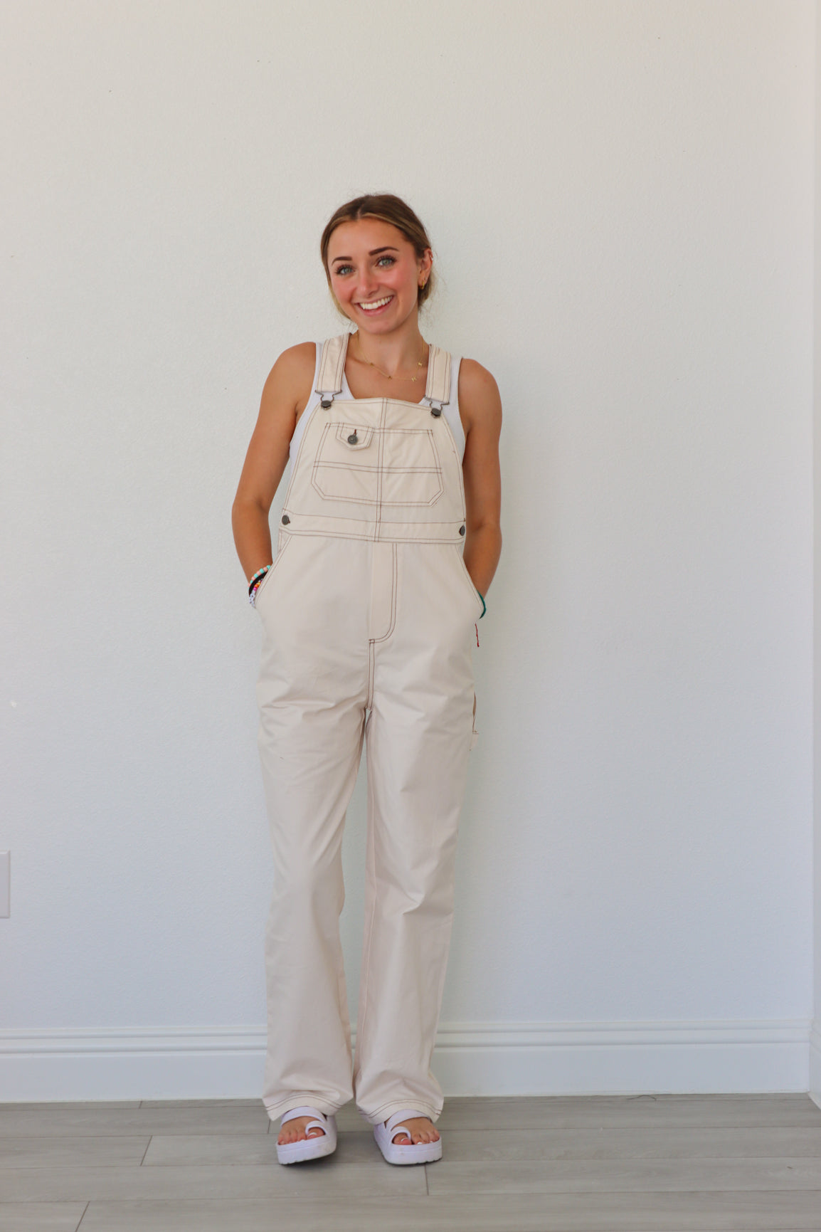 girl wearing cream overalls