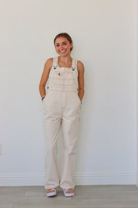 girl wearing cream overalls