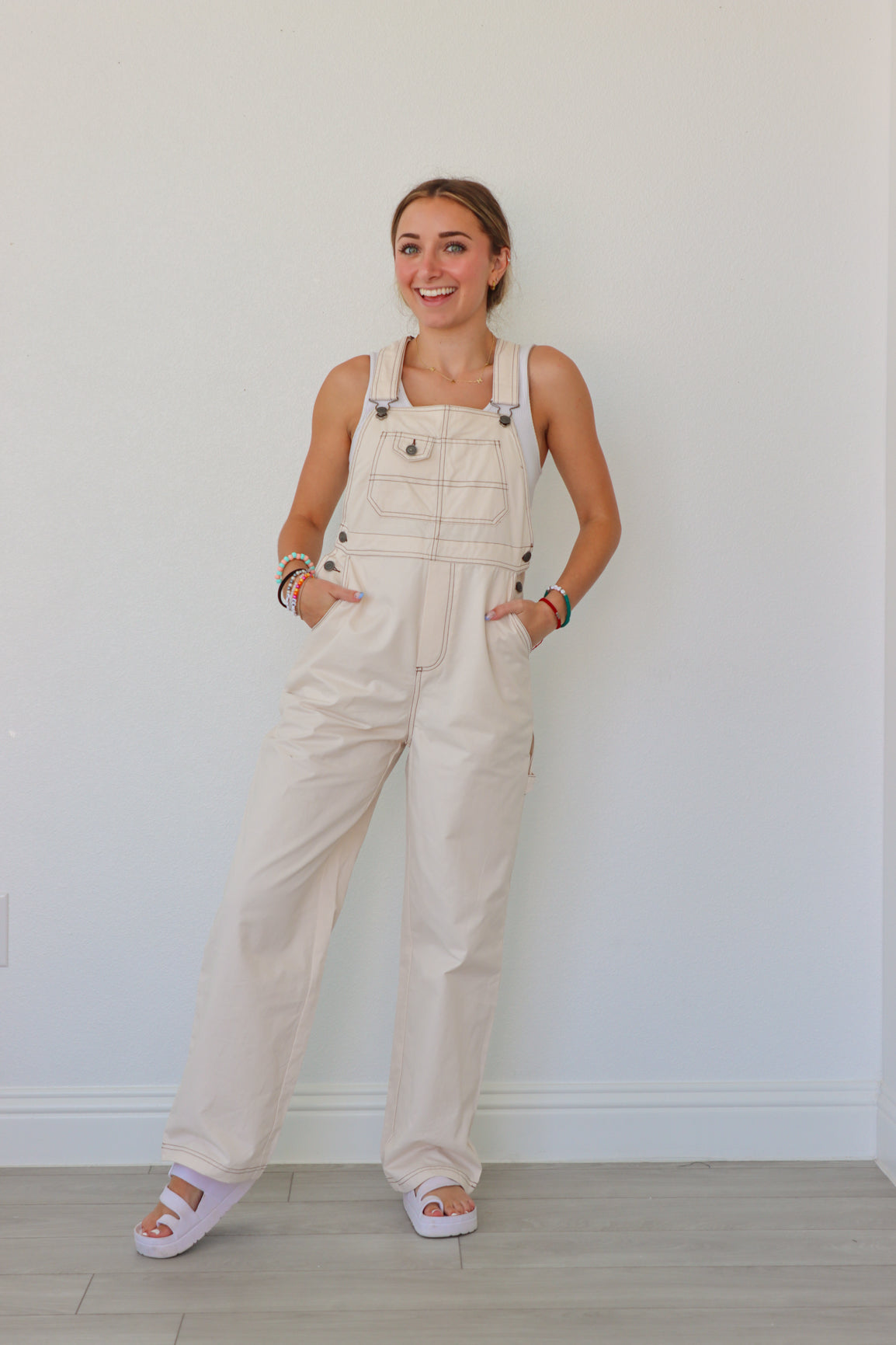 girl wearing cream overalls