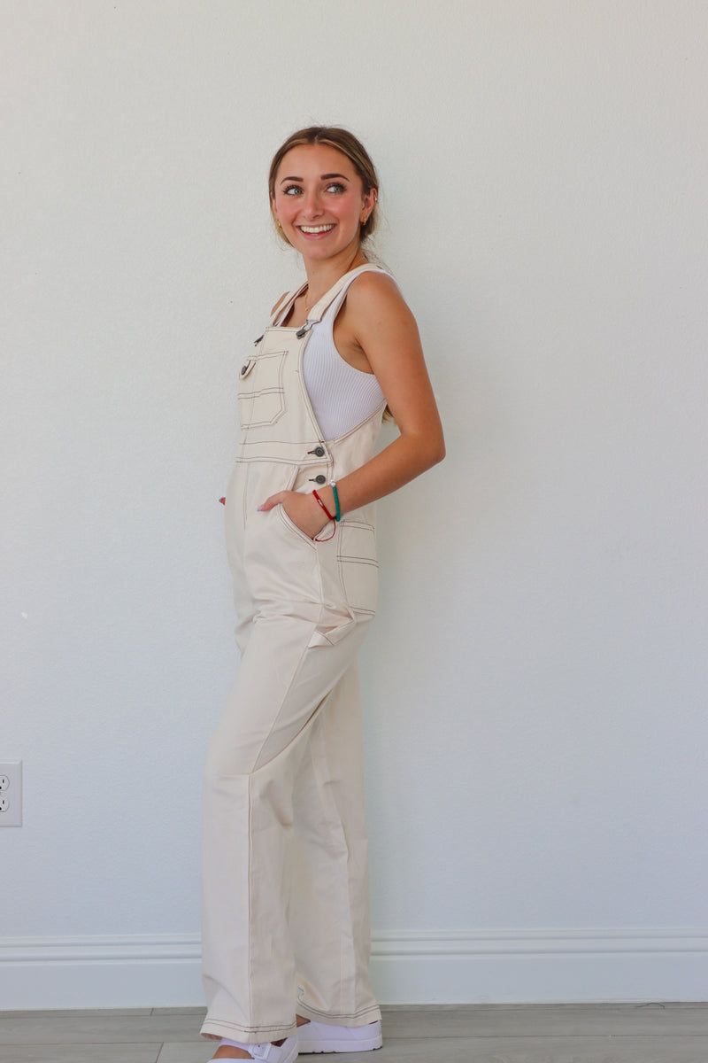 girl wearing cream overalls