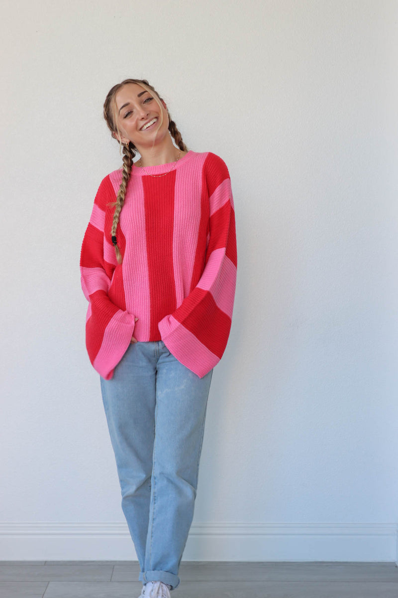 girl wearing hot pink and red striped knit sweater