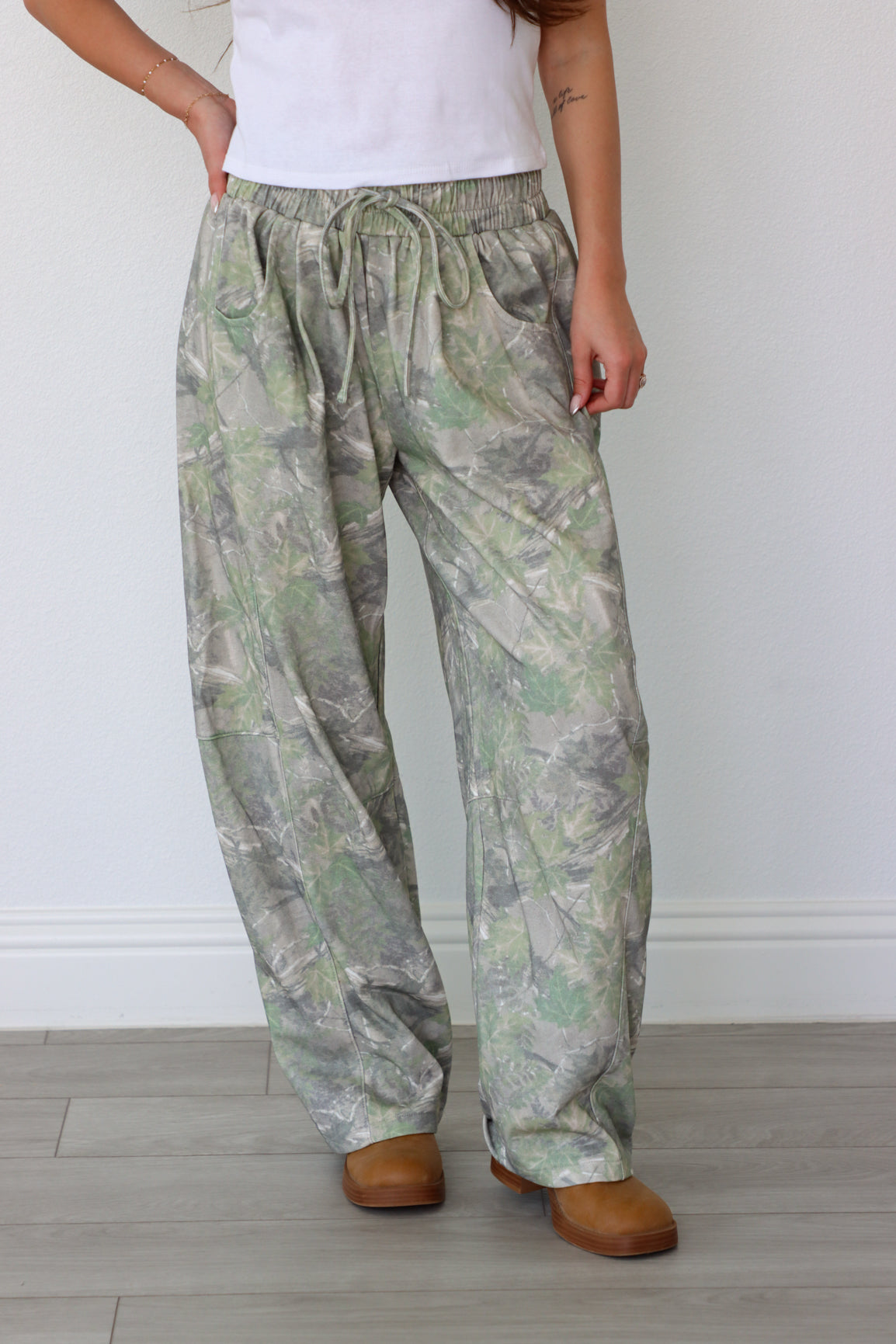 Person wearing green pants with a white background