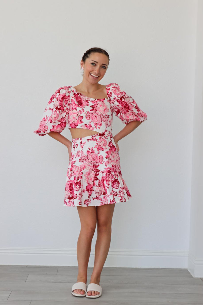 girl wearing short pink floral dress