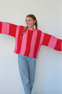 girl wearing hot pink and red striped knit sweater