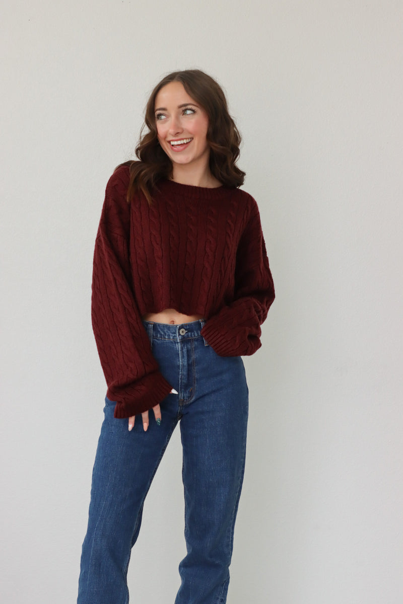 girl wearing dark red cropped knit sweater