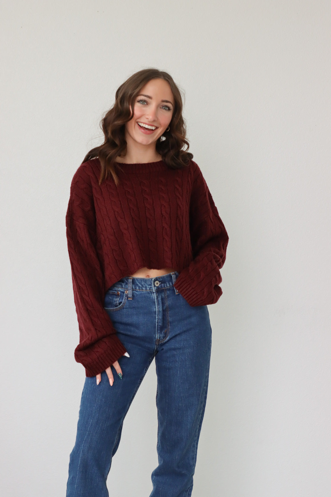 girl wearing dark red cropped knit sweater