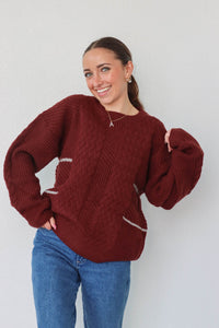 girl wearing dark red knit sweater