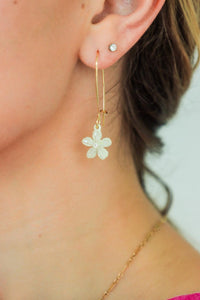 girl wearing white crystal flower earrings