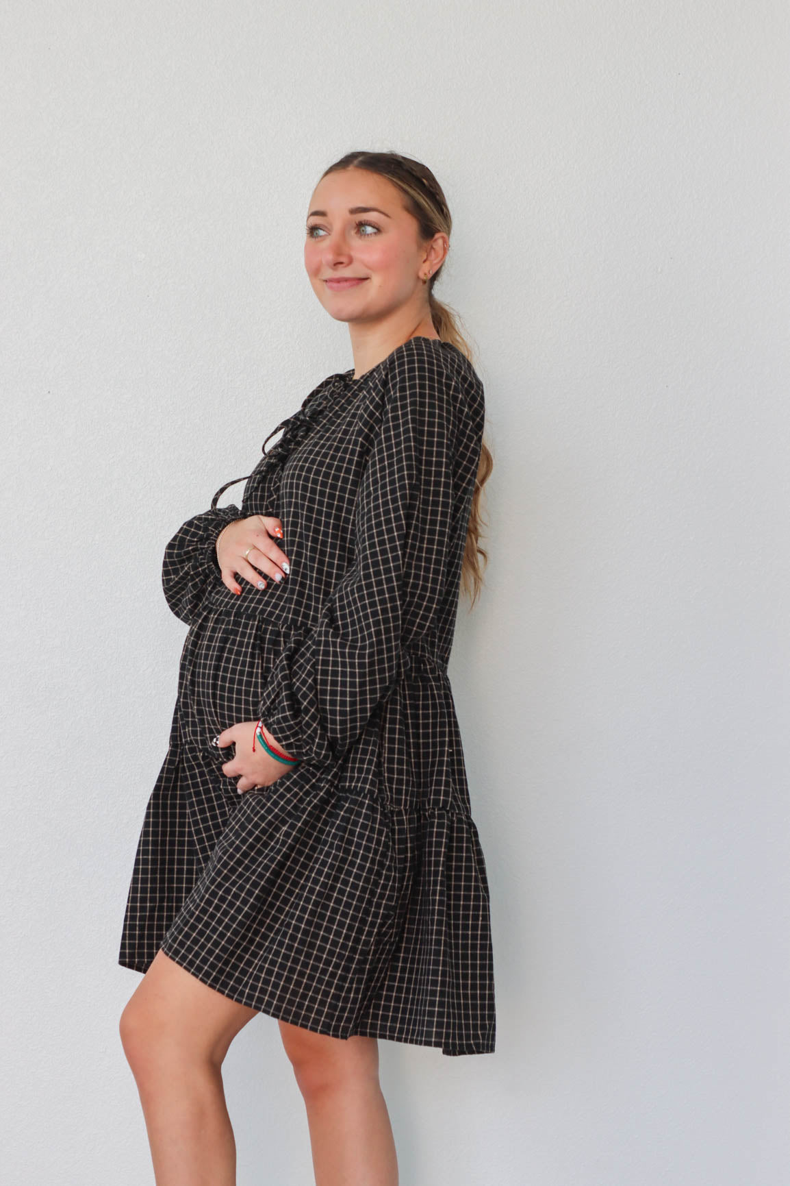 girl wearing black plaid long sleeve dress