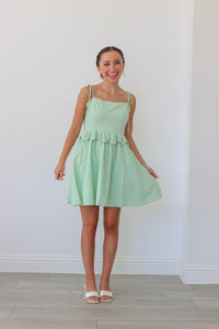 girl wearing light green short dress