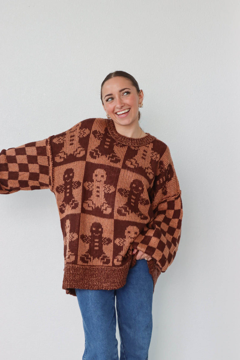 girl wearing brown gingerbread sweater