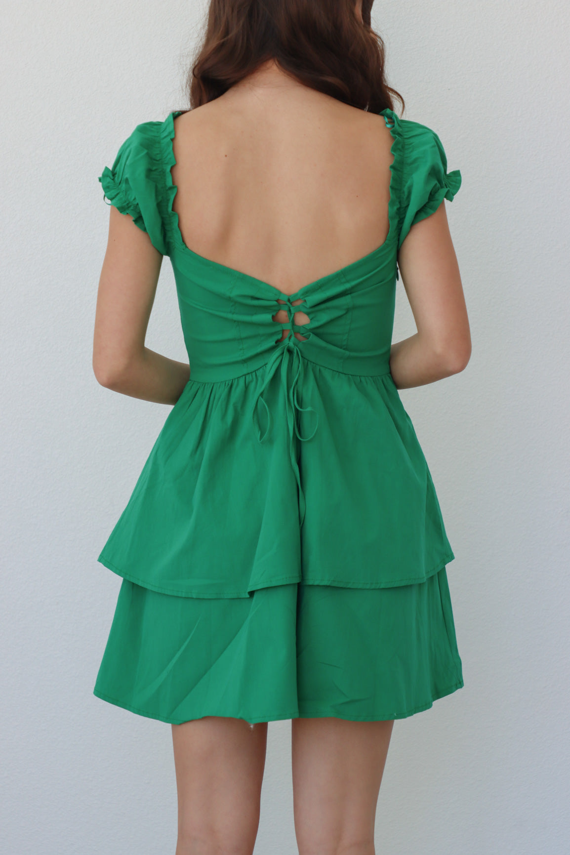 girl wearing emerald green short dress