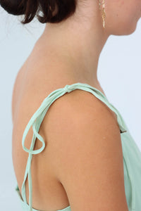 adjustable straps on light green short dress