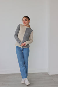 girl wearing gray and cream waffle knit, color blocked long sleeve top