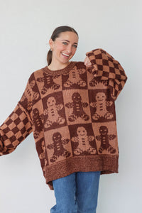 girl wearing brown gingerbread sweater