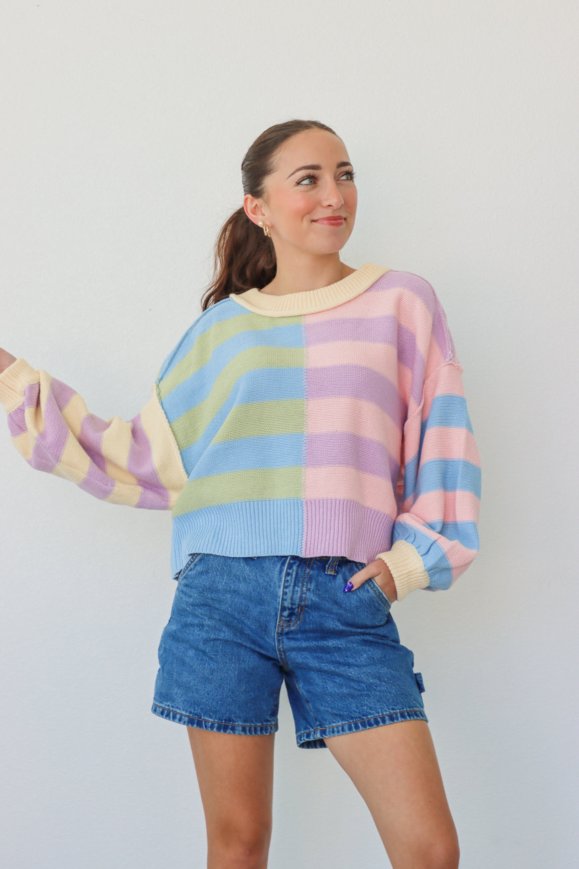 girl wearing pastel multicolor striped knit sweater