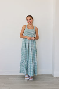 girl wearing blue gingham maxi dress