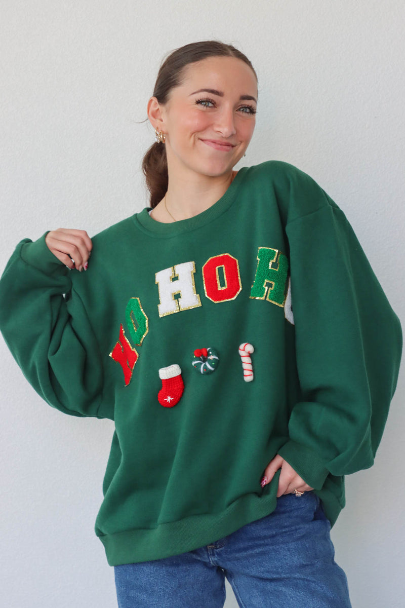 girl wearing dark green "ho ho ho" crewneck