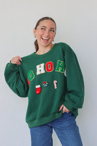 girl wearing dark green "ho ho ho" crewneck