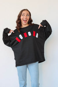 girl wearing black "Ho Ho Ho" crewneck sweatshirt