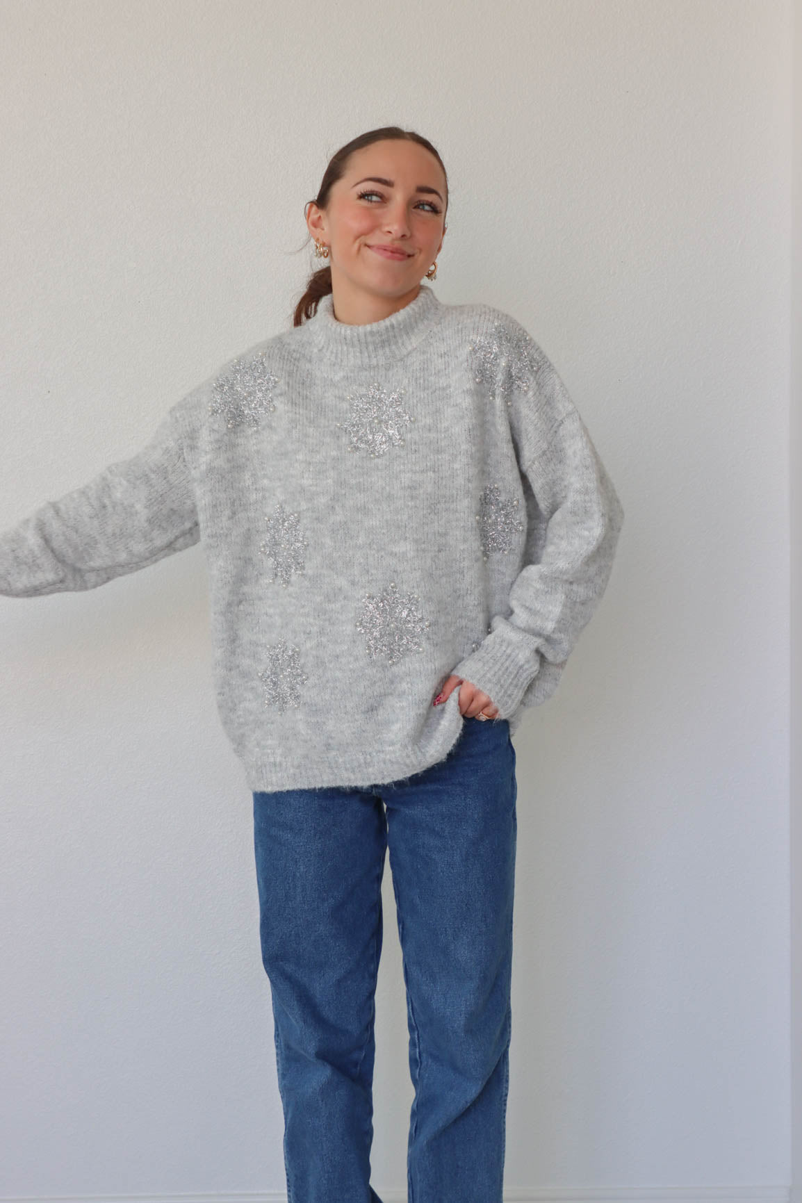 girl wearing gray sparkly snowflake sweater