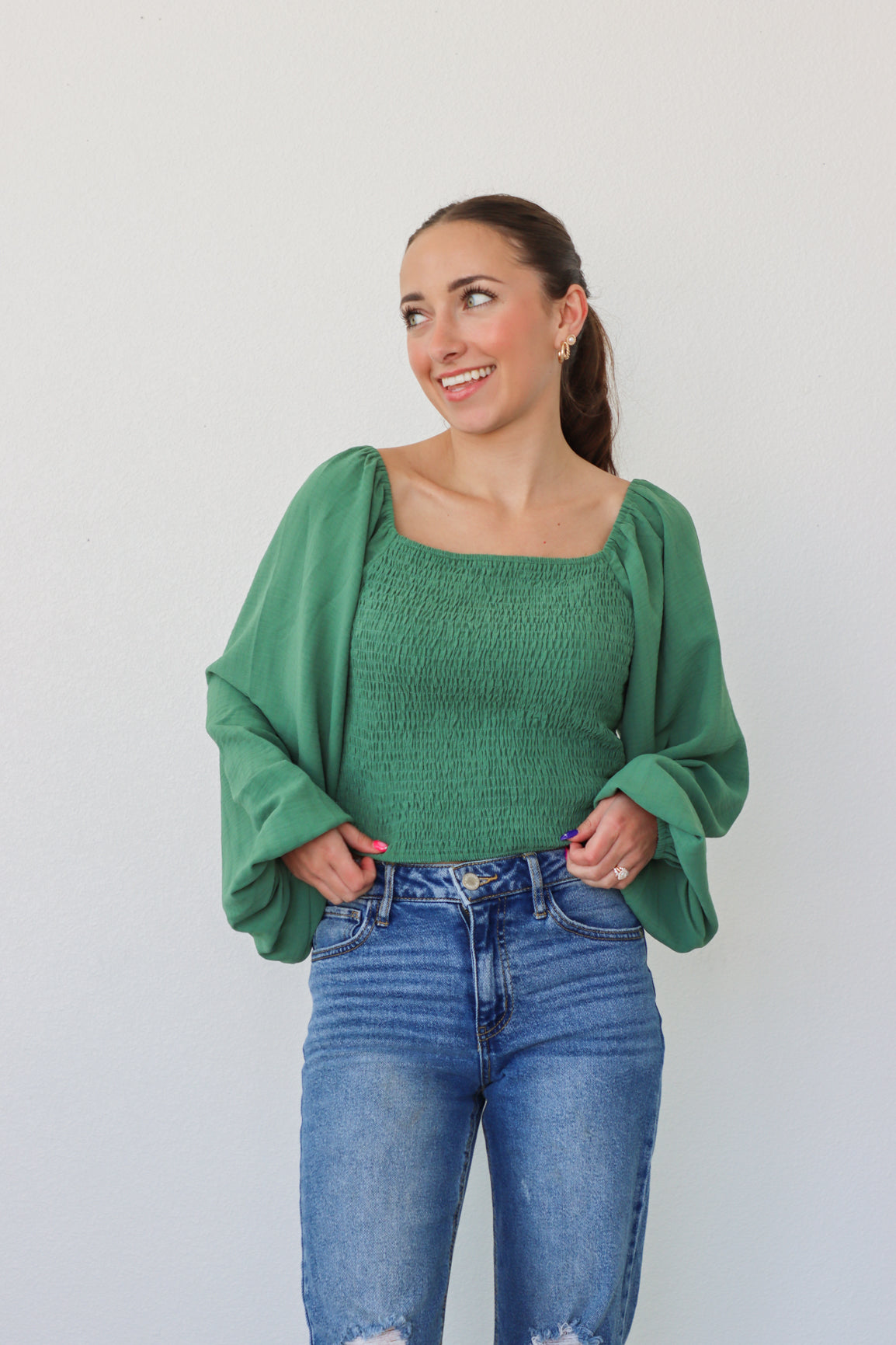 girl wearing green longsleeve top