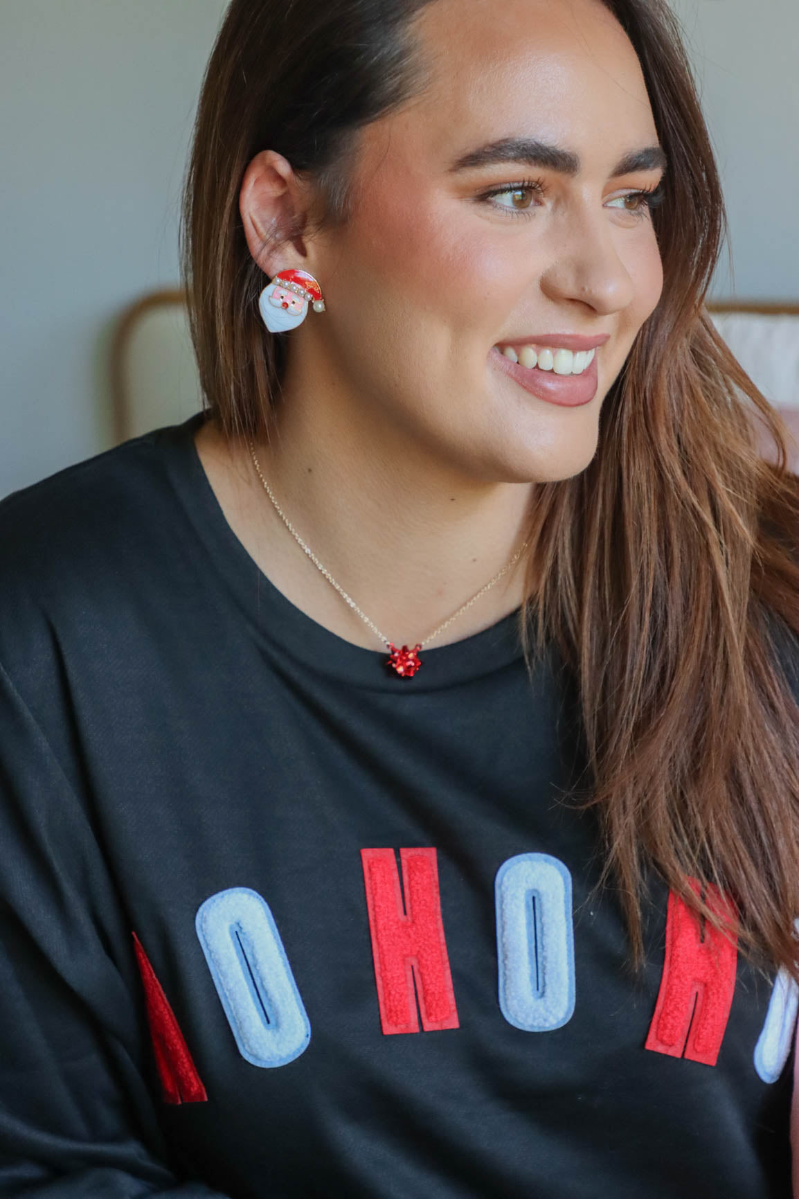 girl wearing santa earrings
