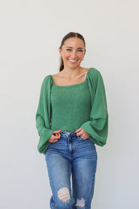 girl wearing green longsleeve top