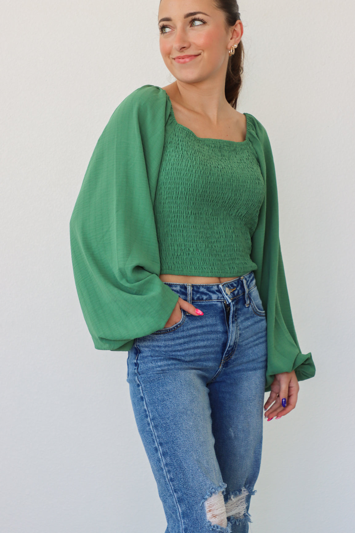 girl wearing green longsleeve top