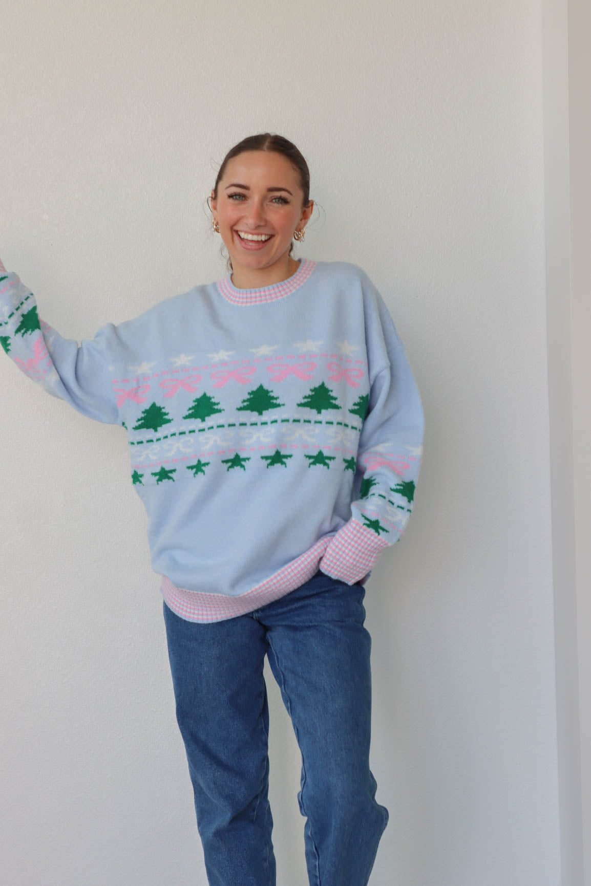 girl wearing light blue holiday sweater