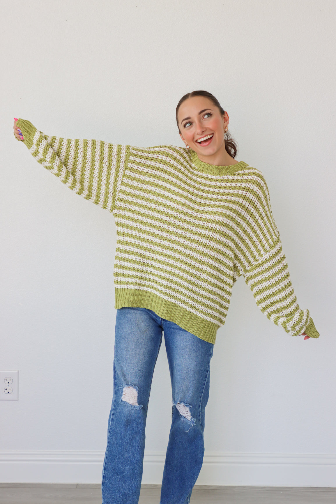 girl wearing lime green and white knit sweater