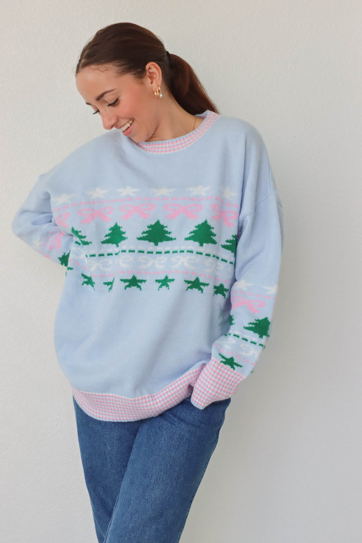 girl wearing light blue holiday sweater