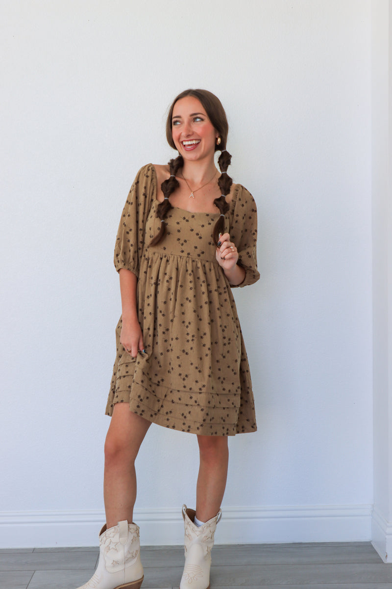 Woman wearing a brown dress with a white background